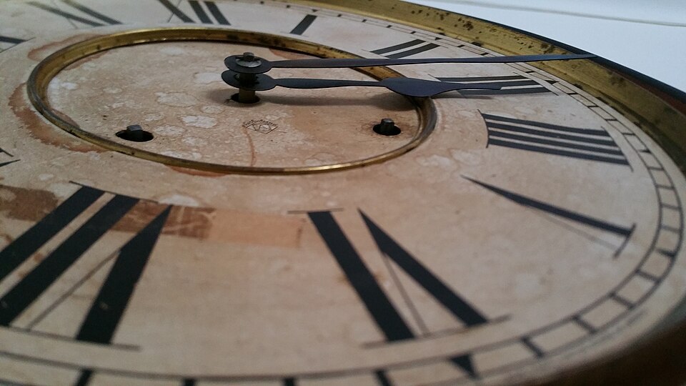 Large, looming clock face shows a time of around 2:15.